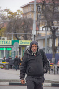 Portrait of man standing on street