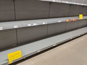 Empty toilet paper shelves in supermarket after panic buying due to outbreaking coronavirus