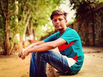 Portrait of young man sitting outdoors