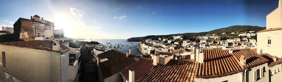 High angle view of townscape by sea against sky