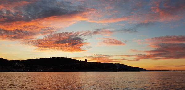 Scenic view of lake against romantic sky at sunset