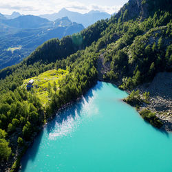 Scenic view of river amidst mountains against sky