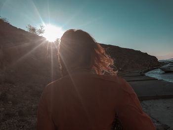 Rear view of woman against sky