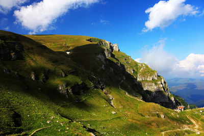 Scenic view of mountains against blue sky