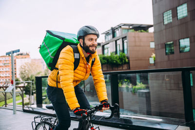 Man riding bicycle on street in city