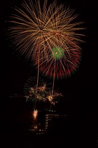 Low angle view of firework display at night