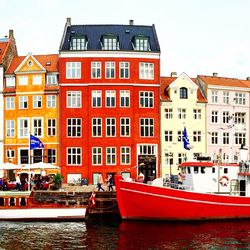 Boats in river with buildings in background