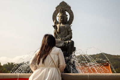 Rear view of woman statue against clear sky