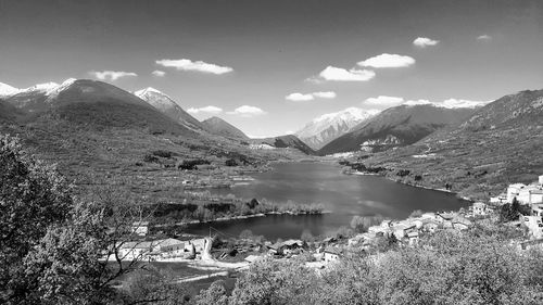 Scenic view of lake and mountains against sky