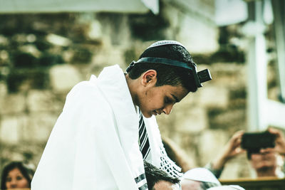 Side view of young man wearing hat