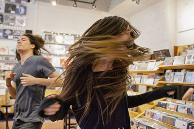 Young people dancing in a record store