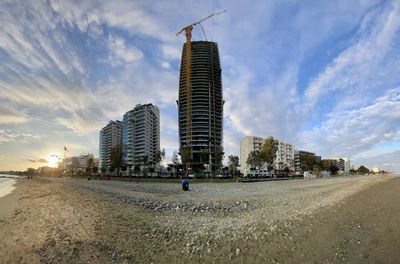 View of city street and buildings against sky