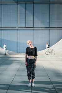 Woman standing against building