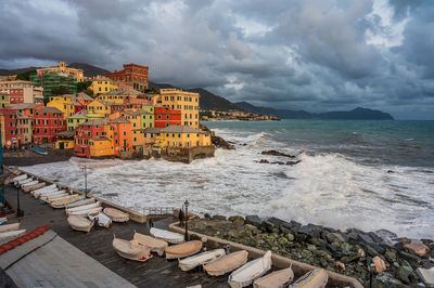 Scenic view of sea by buildings against sky