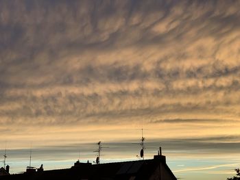 Silhouette buildings against sky during sunset