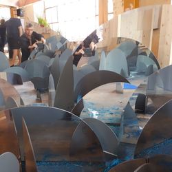 Digital composite image of people sitting in sea