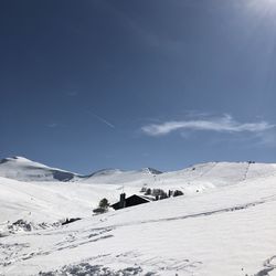 Scenic view of snow covered mountains against sky