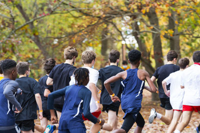 Rear view of people walking outdoors