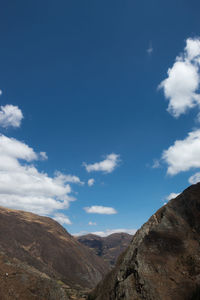Low angle view of mountains against blue sky