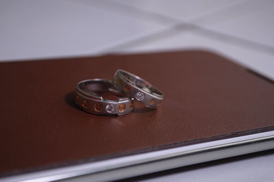 Close-up of wedding rings on table