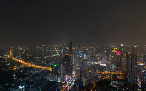 High angle view of illuminated city buildings at night