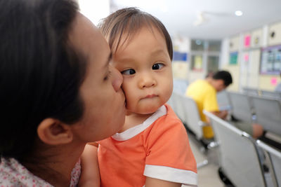 Close-up of mother kissing son