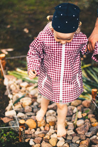 Rear view of friends standing by plants