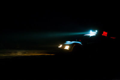Illuminated car on road at night