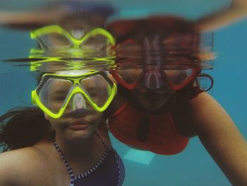 Portrait of friends swimming in sea