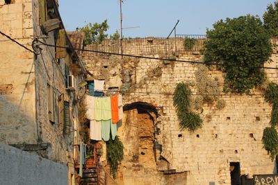 Low angle view of clothesline on old building