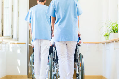 Rear view of people walking in corridor