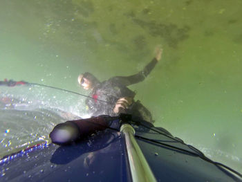 Man windsurfing in sea