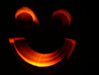 Close-up of light bulb over black background