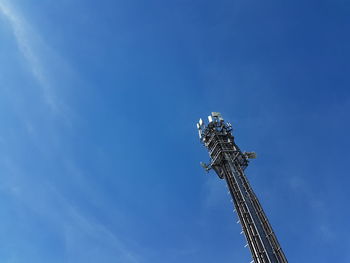 Low angle view of windmill against blue sky