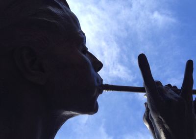 Low angle view of statue against cloudy sky