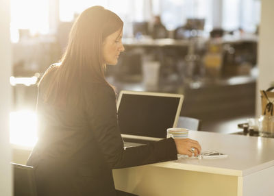 Businesswoman sitting at desk in office