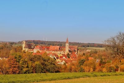 Houses in town against clear sky