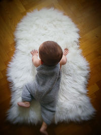 High angle view of baby on flooring