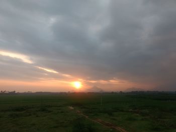 Scenic view of field against sky during sunset