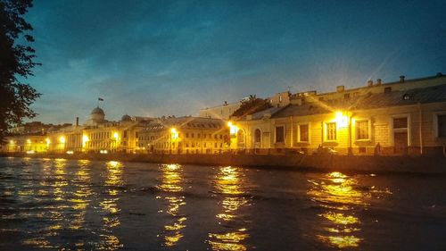 Reflection of illuminated buildings in water at night