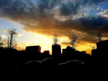 Silhouette of building against dramatic sky