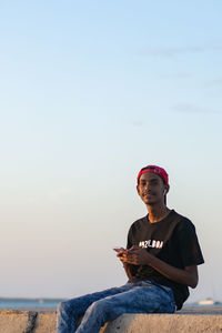 Portrait of young man sitting on beach