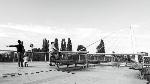 Woman standing by railing