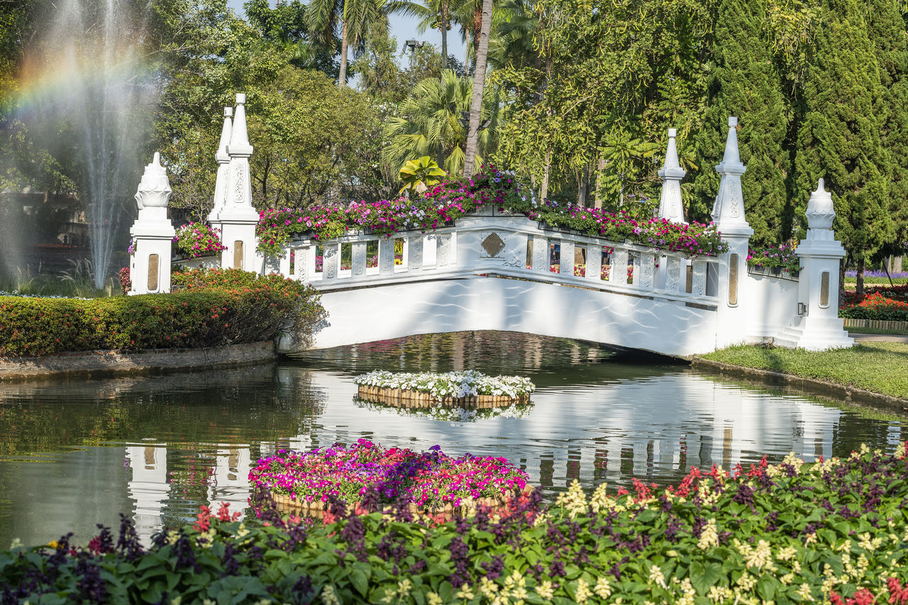 FOUNTAIN IN PARK BY LAKE IN GARDEN