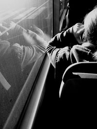 Low section of woman sitting in train