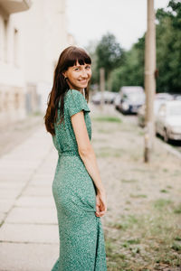 Portrait of smiling young woman standing outdoors