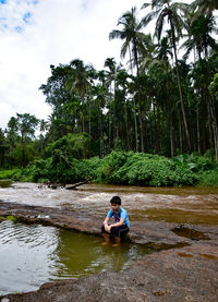 Boy sitting in water