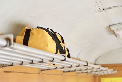 Yellow bag on shelf in train