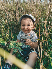 Portrait of cute boy on field