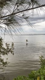 Scenic view of lake against cloudy sky